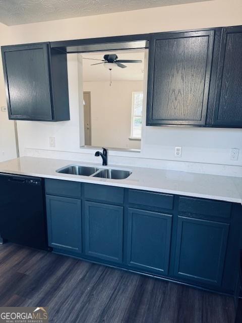 kitchen featuring dishwasher, a textured ceiling, dark wood-type flooring, ceiling fan, and sink