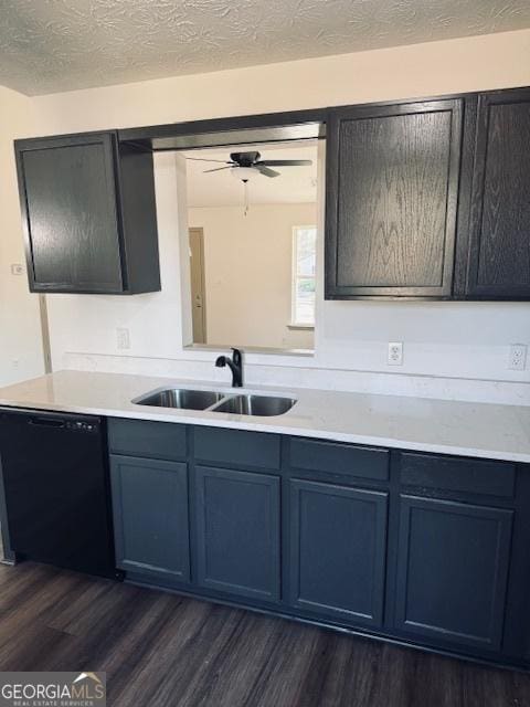 kitchen featuring dishwasher, a textured ceiling, dark wood-type flooring, ceiling fan, and sink