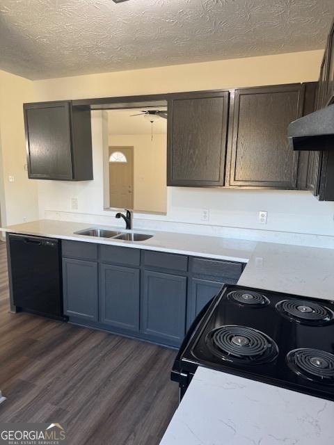 kitchen with sink, a textured ceiling, dark brown cabinets, dark hardwood / wood-style floors, and black appliances