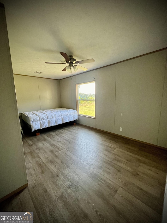 unfurnished bedroom featuring ceiling fan and hardwood / wood-style floors