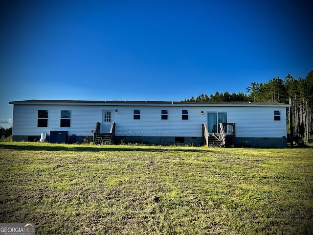 view of front of house with a front yard and central AC unit