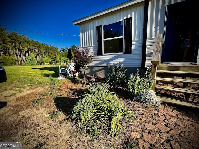 view of property exterior featuring a lawn