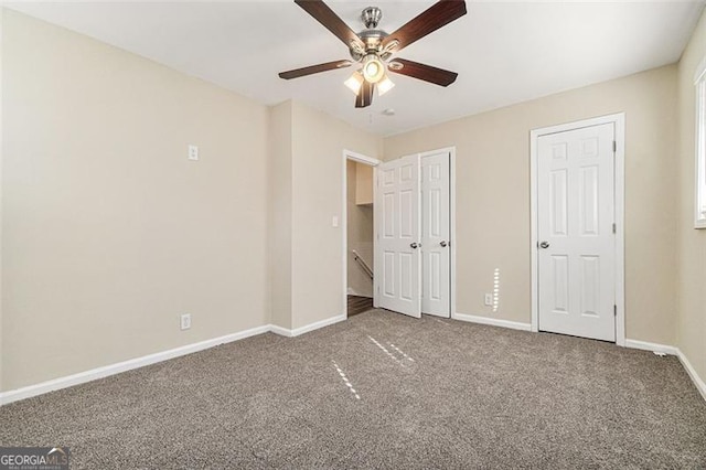 unfurnished bedroom featuring carpet floors and ceiling fan