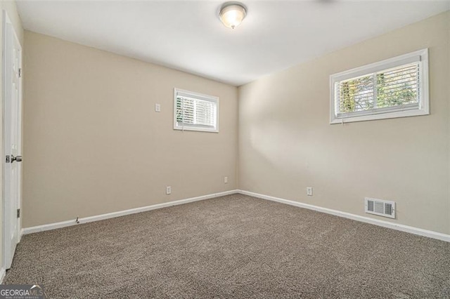 carpeted spare room with a healthy amount of sunlight