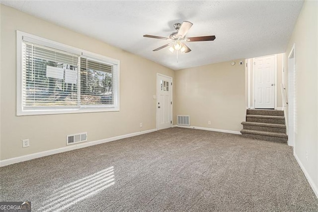 spare room featuring carpet floors and ceiling fan