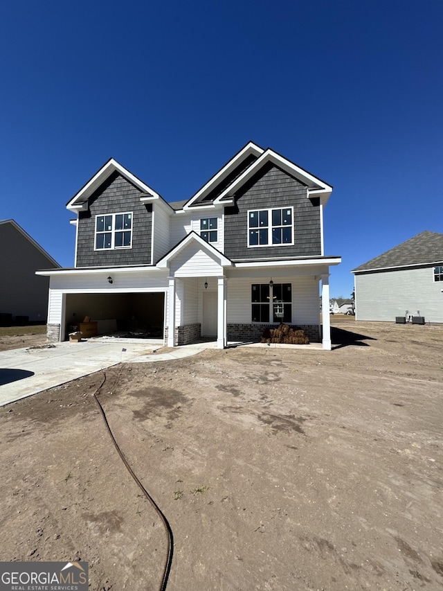 craftsman-style house with a garage and concrete driveway