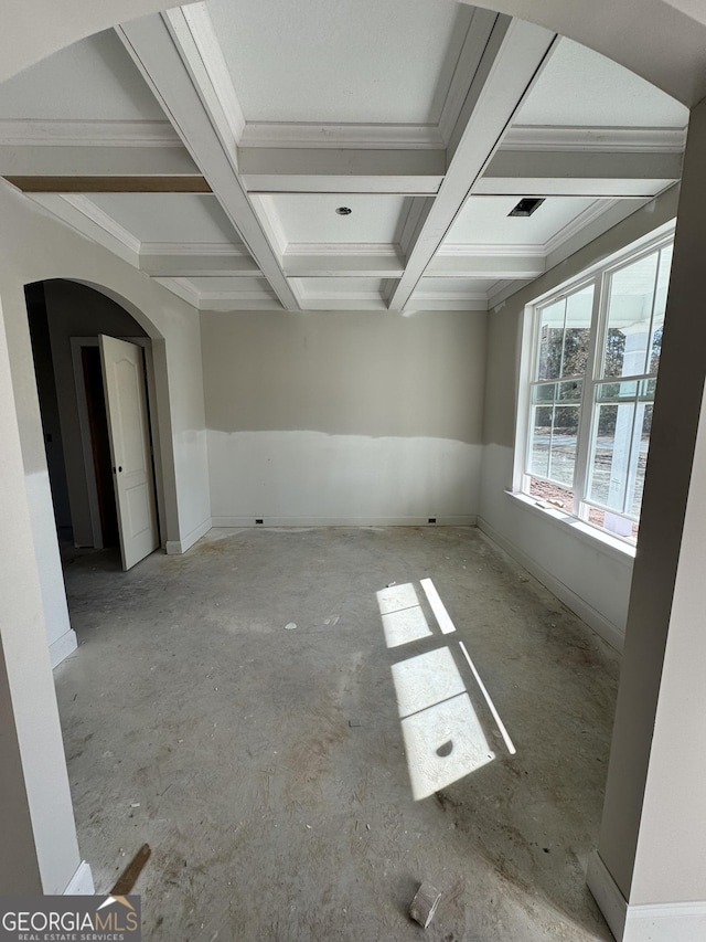 spare room featuring visible vents, arched walkways, coffered ceiling, ornamental molding, and beamed ceiling