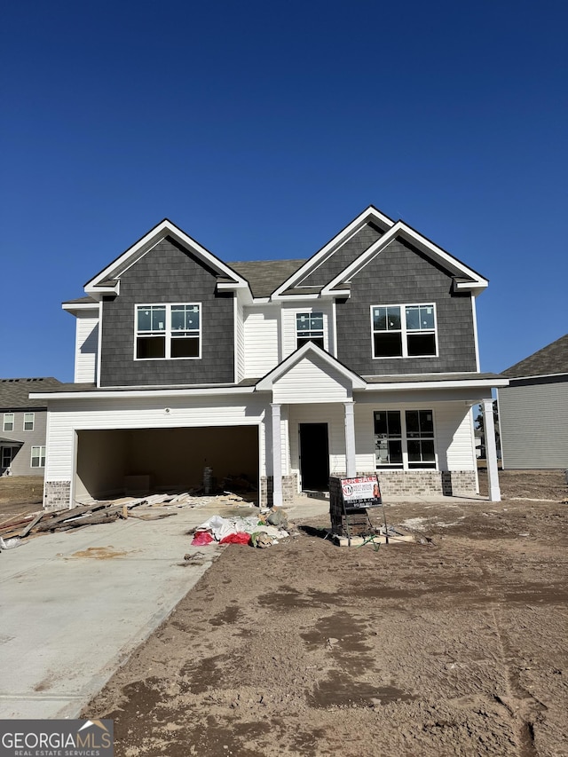 view of front of property with a garage and concrete driveway