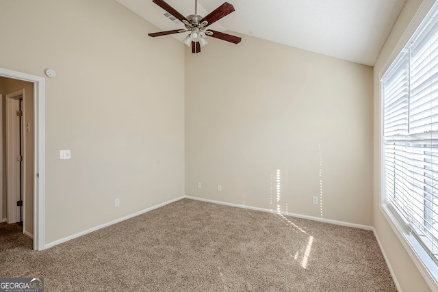 empty room with lofted ceiling, carpet flooring, and ceiling fan