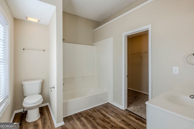 bathroom with toilet, vanity, and hardwood / wood-style flooring