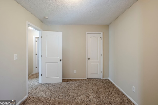 unfurnished bedroom with carpet flooring and a textured ceiling