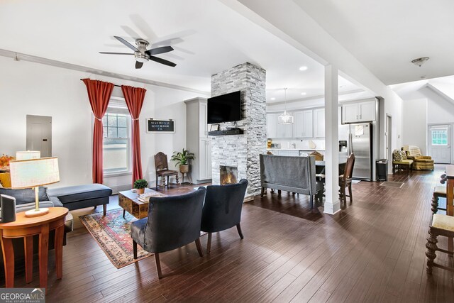 dining room featuring electric panel, a fireplace, ceiling fan, and dark hardwood / wood-style flooring