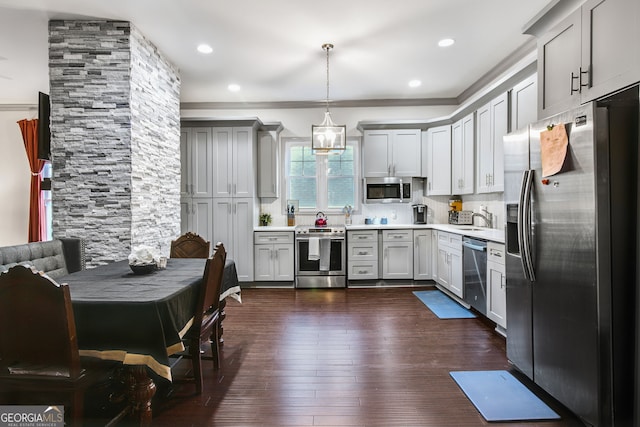 kitchen featuring stainless steel appliances, decorative backsplash, gray cabinets, dark hardwood / wood-style flooring, and pendant lighting