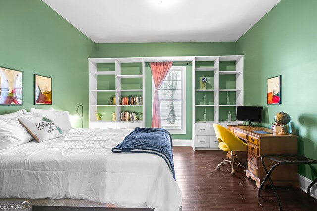 bedroom with dark hardwood / wood-style flooring