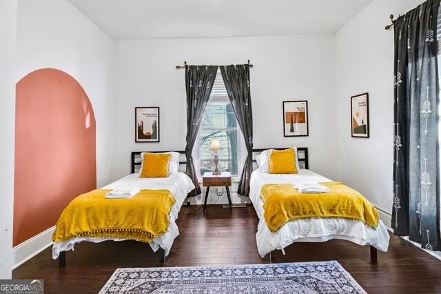 bedroom with dark hardwood / wood-style flooring