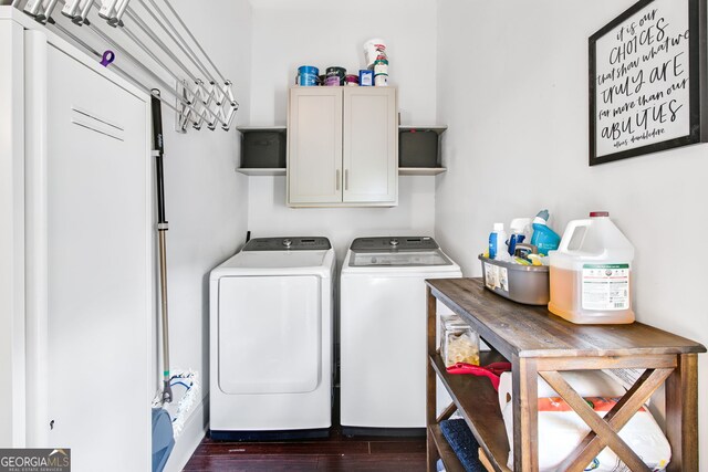 washroom with washer and clothes dryer, cabinets, and dark hardwood / wood-style floors