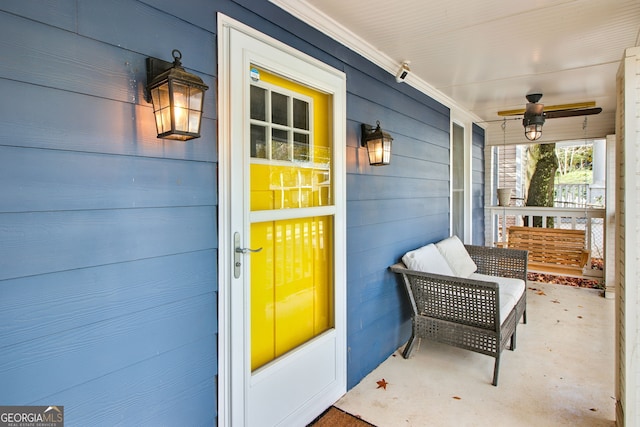 doorway to property with a porch and ceiling fan