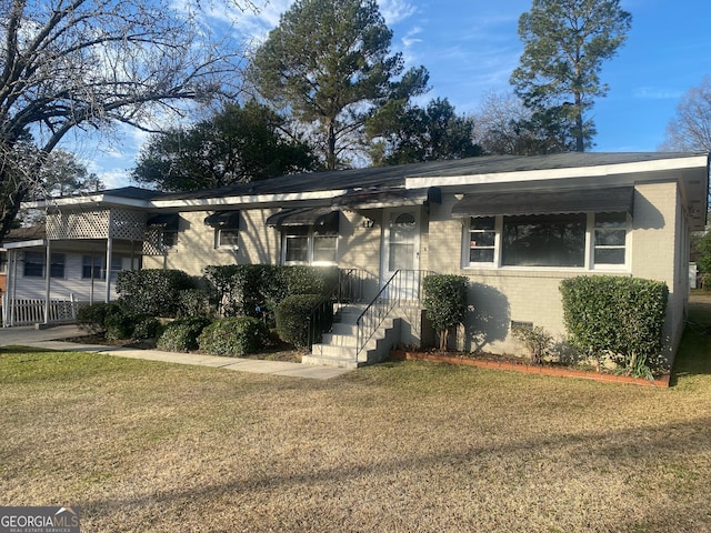 ranch-style house with a front lawn