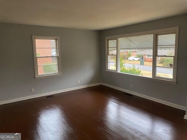 unfurnished room featuring dark hardwood / wood-style floors