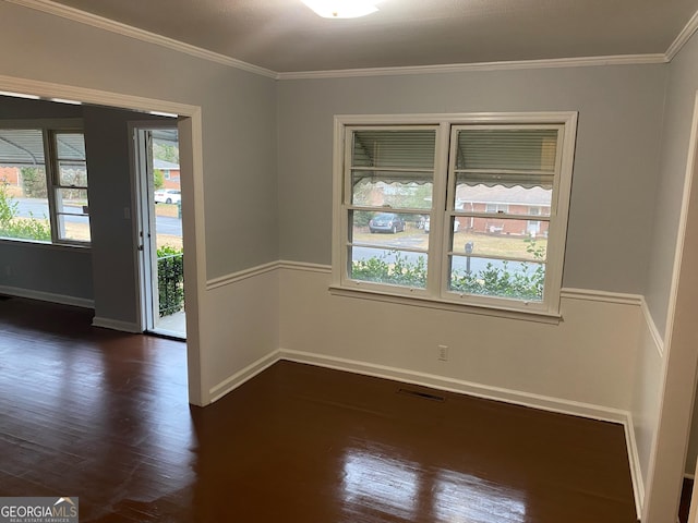 empty room with crown molding and dark hardwood / wood-style floors