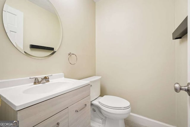 bathroom featuring toilet and vanity