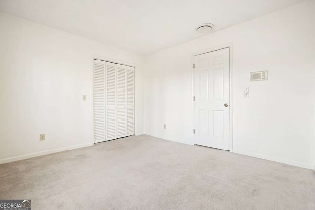 unfurnished bedroom with light colored carpet