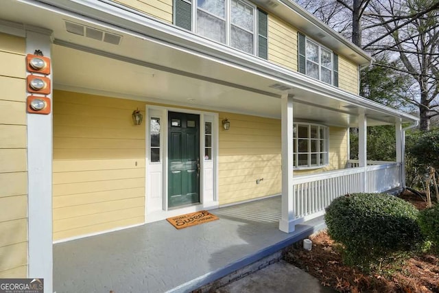 entrance to property featuring covered porch