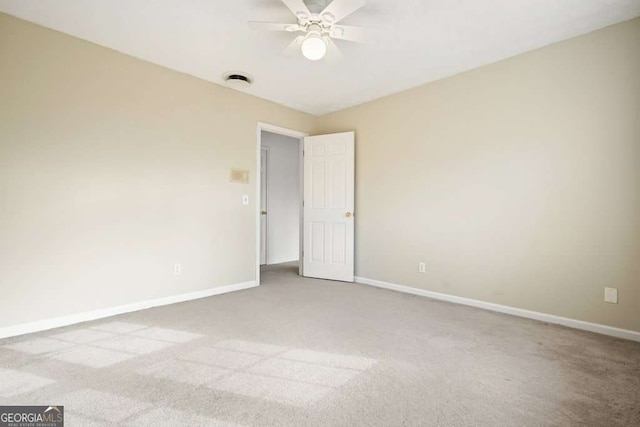 unfurnished room with ceiling fan and light carpet