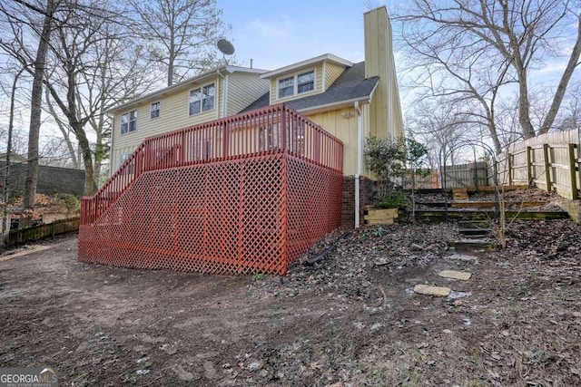 rear view of property with a wooden deck