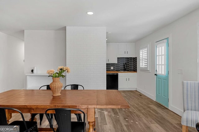 dining room featuring sink and light hardwood / wood-style floors