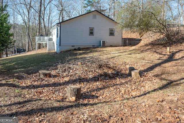 view of property exterior with a wooden deck and central AC