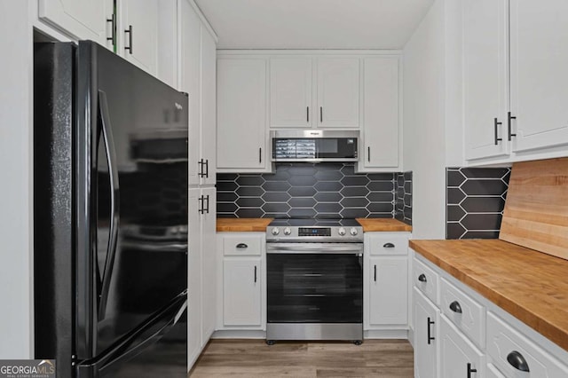 kitchen with light hardwood / wood-style flooring, backsplash, stainless steel appliances, and white cabinetry