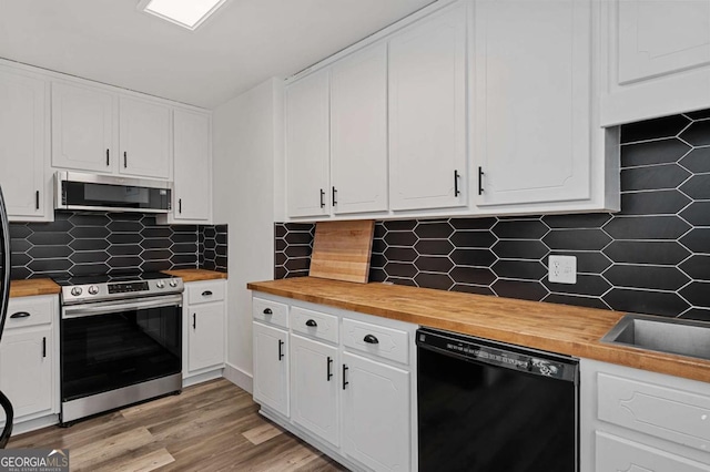 kitchen with white cabinetry, backsplash, and appliances with stainless steel finishes