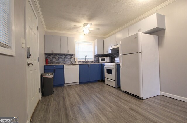 kitchen with white appliances, light wood-type flooring, ceiling fan, sink, and blue cabinets