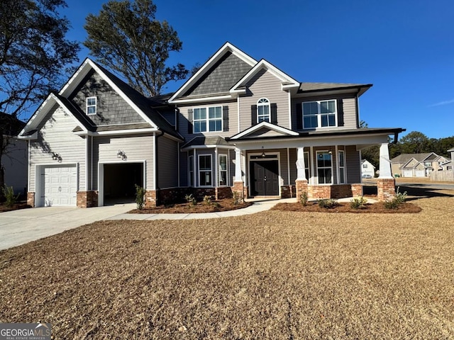 craftsman inspired home featuring covered porch and a garage