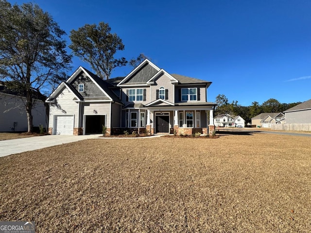 craftsman inspired home featuring a garage, covered porch, and a front lawn