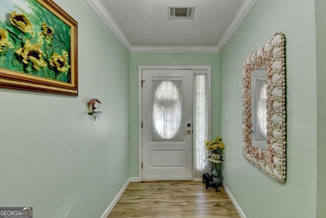 doorway to outside featuring light hardwood / wood-style floors and crown molding