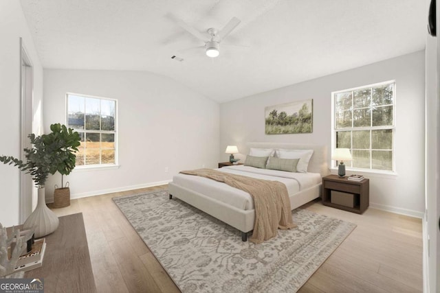 bedroom with lofted ceiling, light wood-type flooring, and ceiling fan