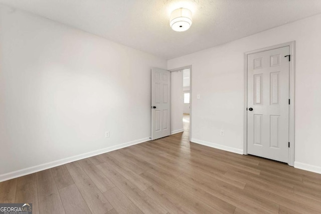 unfurnished room with light hardwood / wood-style floors