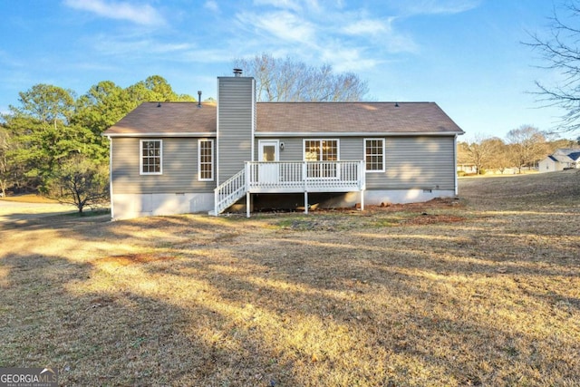 back of house with a yard and a deck