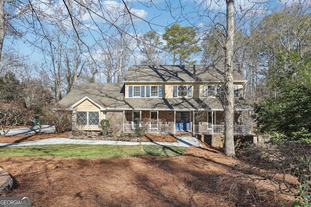 colonial-style house featuring covered porch