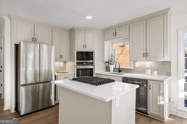 kitchen featuring sink, dark hardwood / wood-style floors, black appliances, and a center island