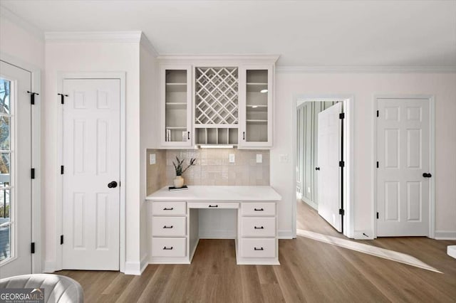 home office with ornamental molding and hardwood / wood-style floors