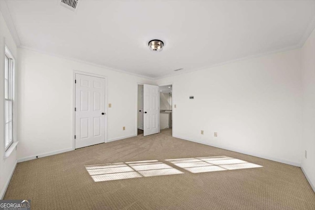 unfurnished bedroom with ornamental molding and light carpet