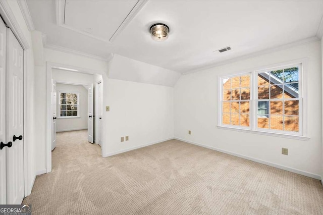 bonus room featuring lofted ceiling and light colored carpet