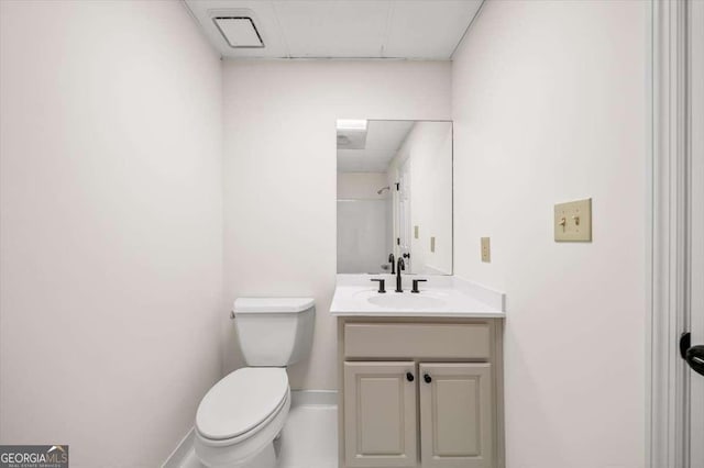 bathroom featuring toilet and vanity