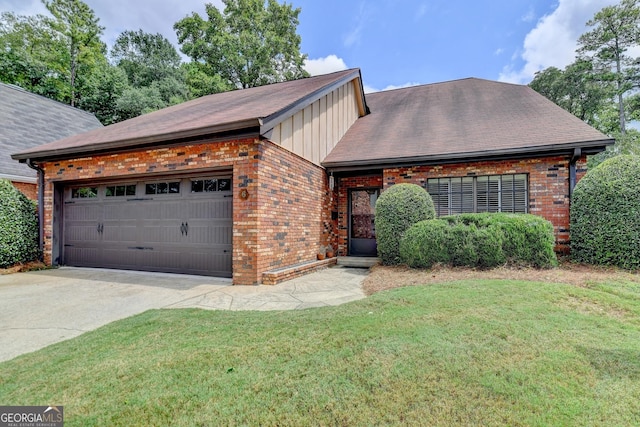 view of front of property with a front lawn and a garage