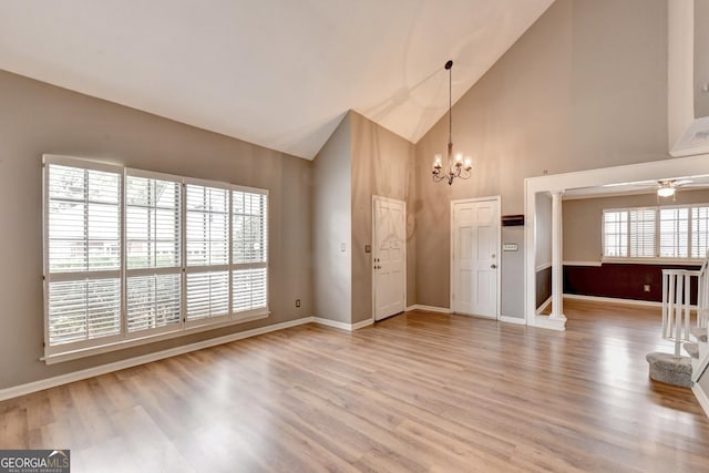 entrance foyer featuring high vaulted ceiling, ceiling fan with notable chandelier, and wood-type flooring