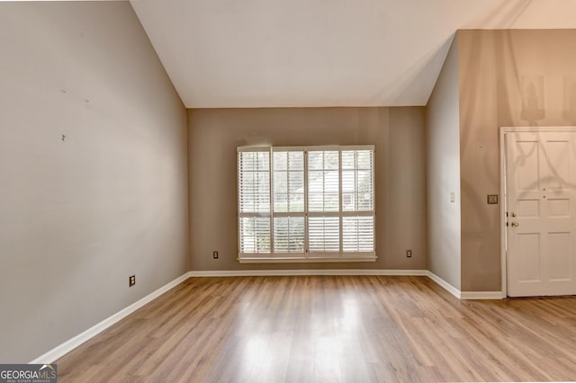 foyer entrance featuring lofted ceiling and light hardwood / wood-style flooring