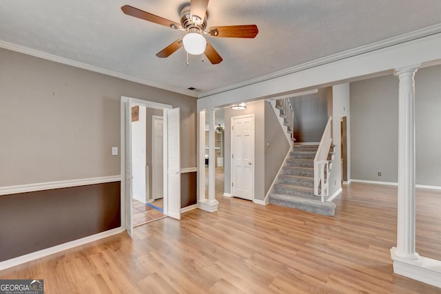 unfurnished room featuring a textured ceiling, ceiling fan, ornamental molding, and light hardwood / wood-style floors